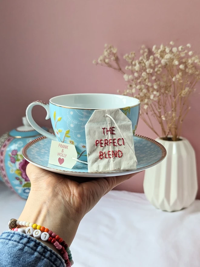 Embroidered The perfect Blend teabag on cup and saucer