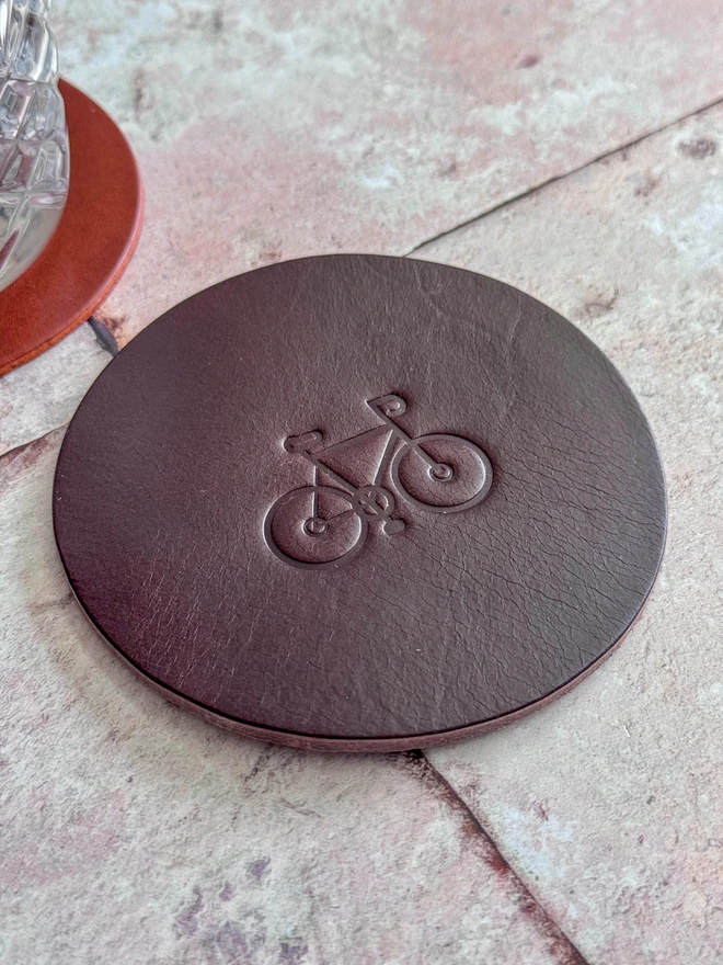 Leather coaster with bike deboss