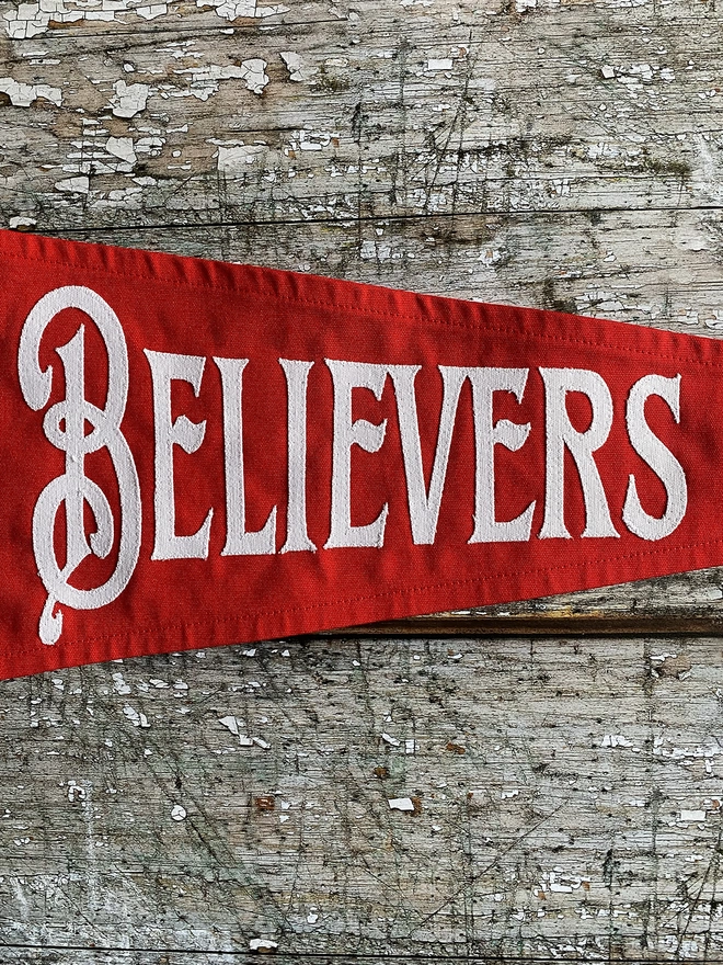 Detail of a red The true believers pennant flag