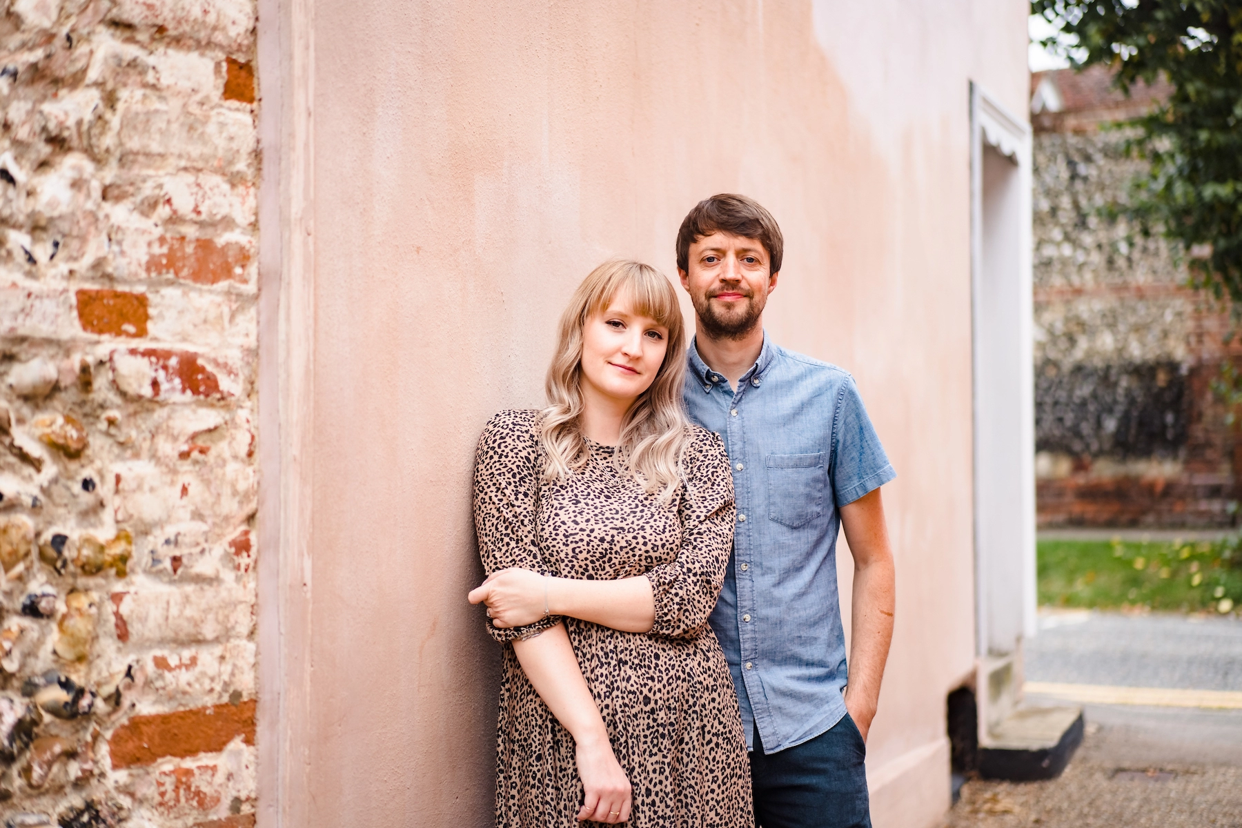 Hayley and Lucas, founders of Alphabet Bags, standing in front of a pink wall