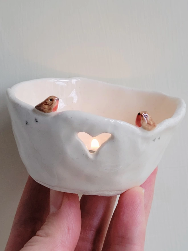 ceramic bird tea light candle holder with robin couple and bird prints and lit candle