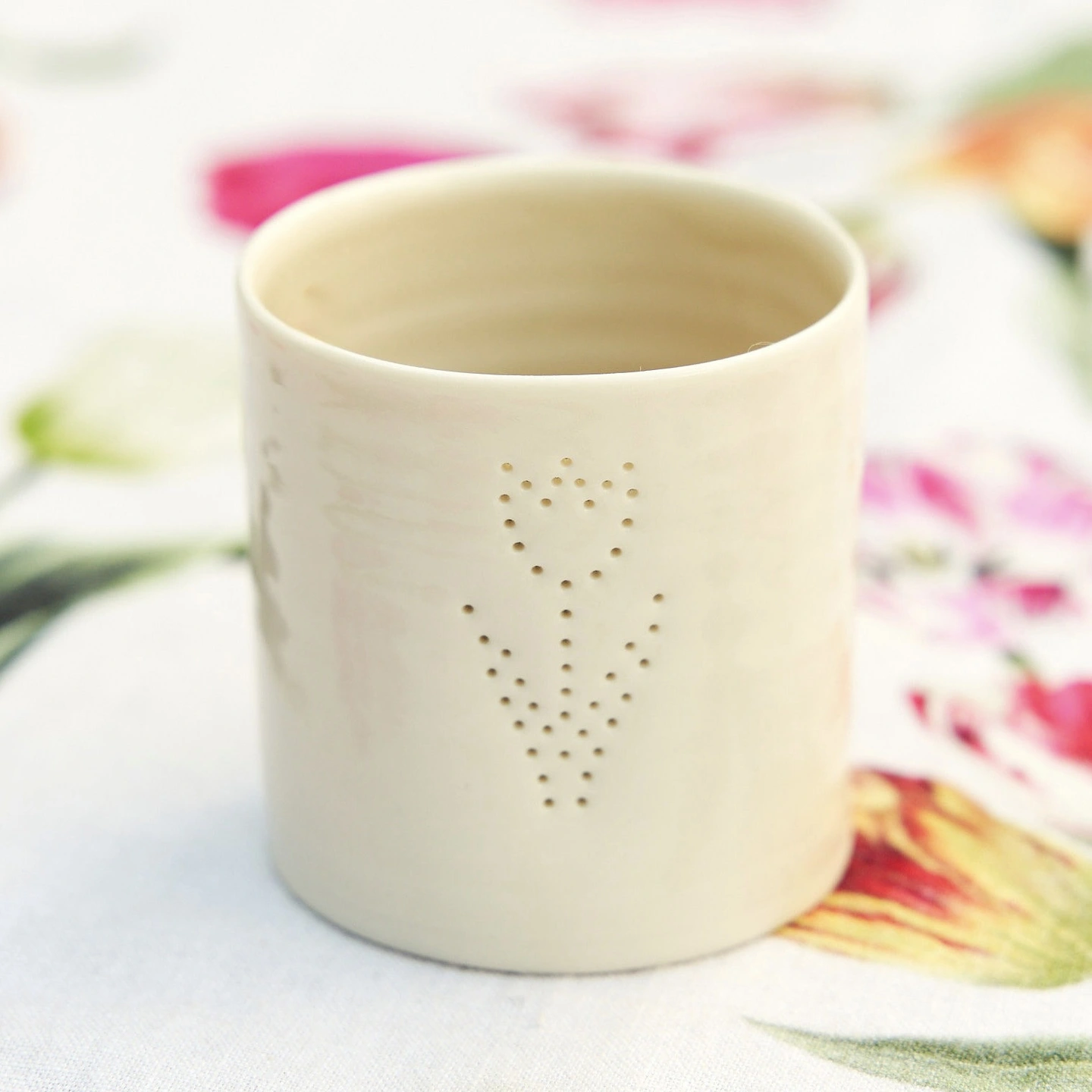 Tulip tea light. A porcelain tea light holder with a tulip shaped formed out of holes.
