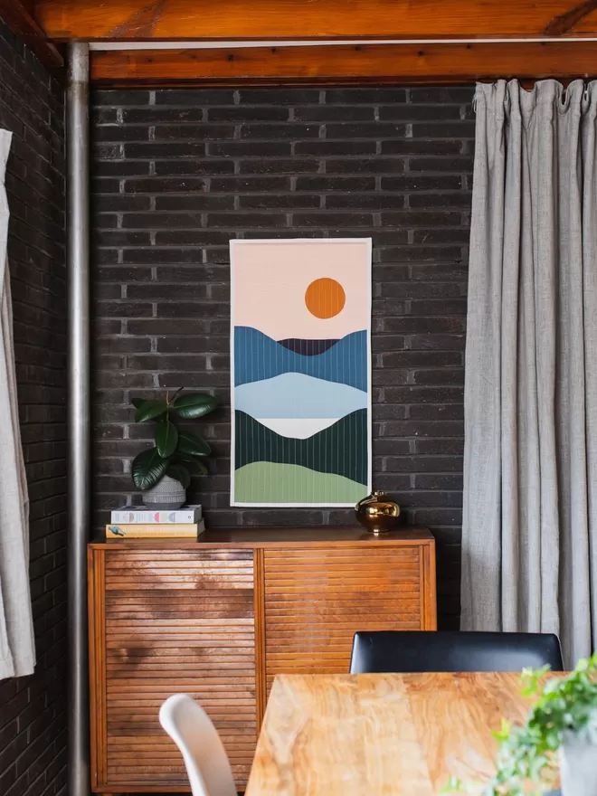 Lakeview Quilt Hanging On Wall Above Wooden Furniture In Dining Room