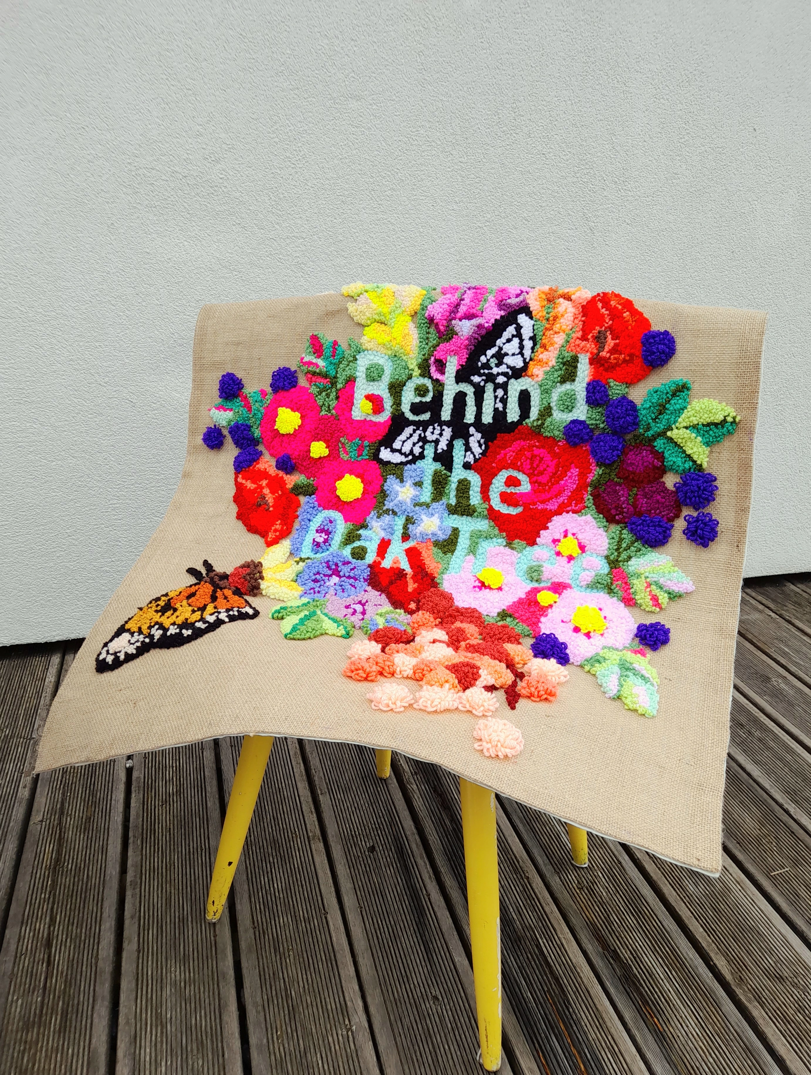 Behind the Oak Tree wall hanging on yellow chair