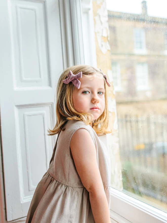 girls by window and wearing hair bows