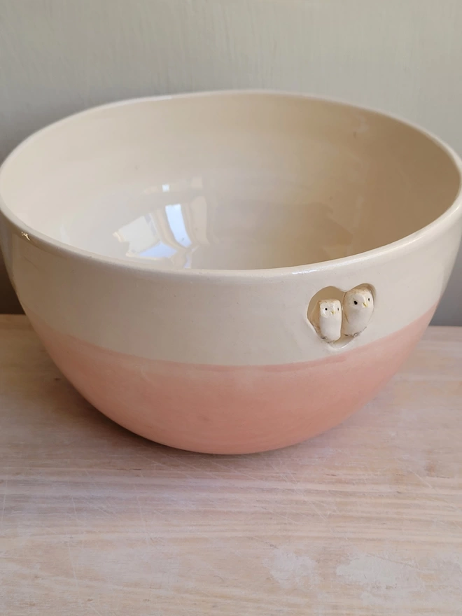 hand made pink and off white ceramic bowl with a heart cut out with two tiny ceramic owls sitting in the cut out heart