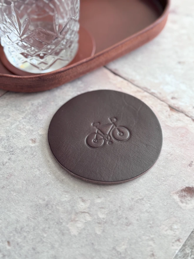 Leather coaster with bike deboss