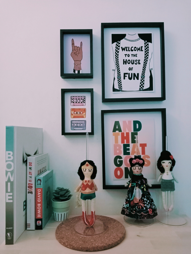Display arrangement showing a collection of mini decorative icon dolls. Inspirational women collection. Showing wonder woman Frida kahlo and Amy Winehouse dolls.