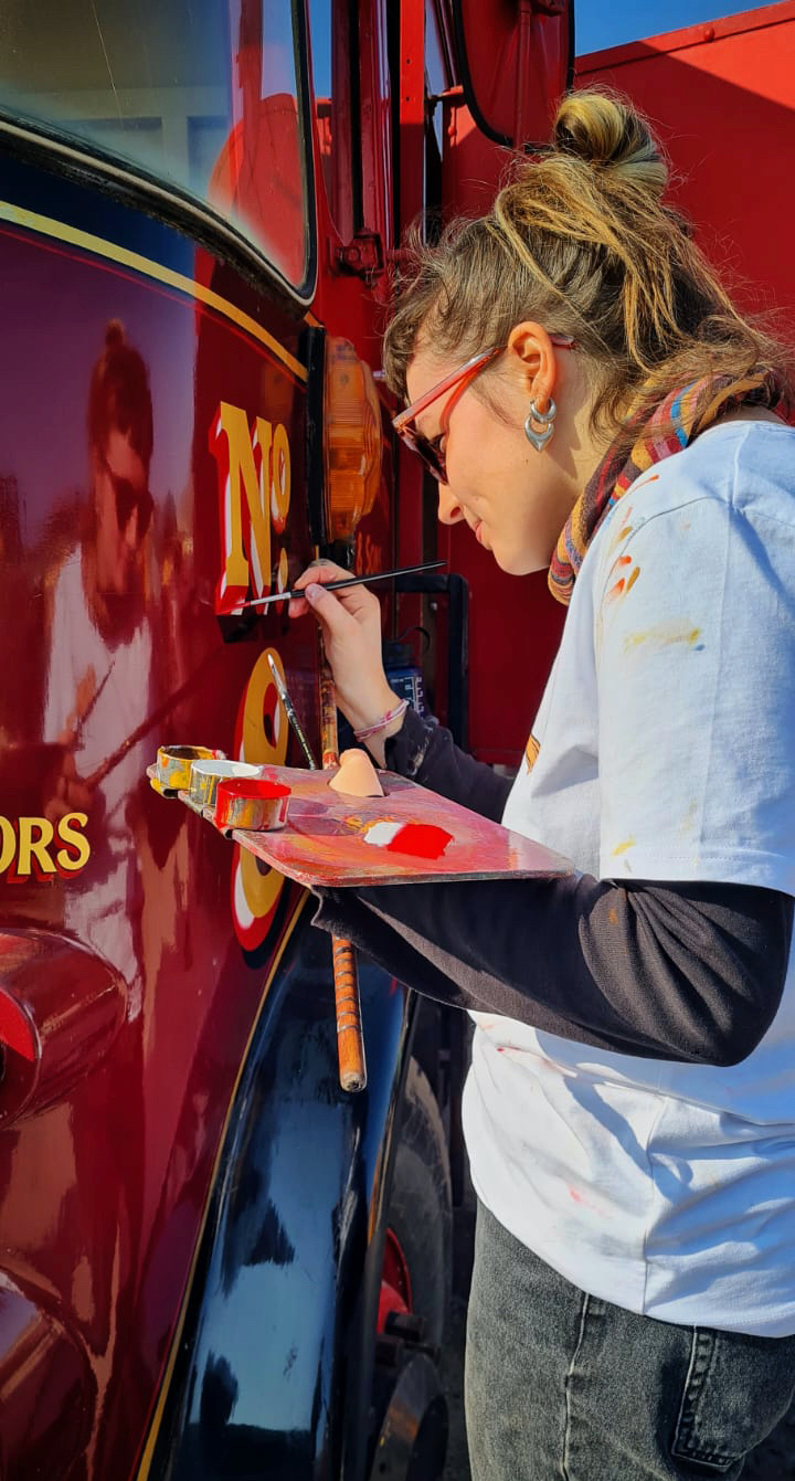 Jess Grimsdale signwriting a lorry