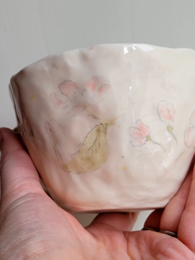 pink floral flowered handmade ceramic tea cup held in a hand looking gloriousup ha