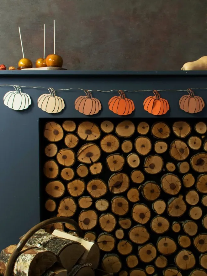 Ombre mix of paper pumpkin decorations displayed on black mantelpiece