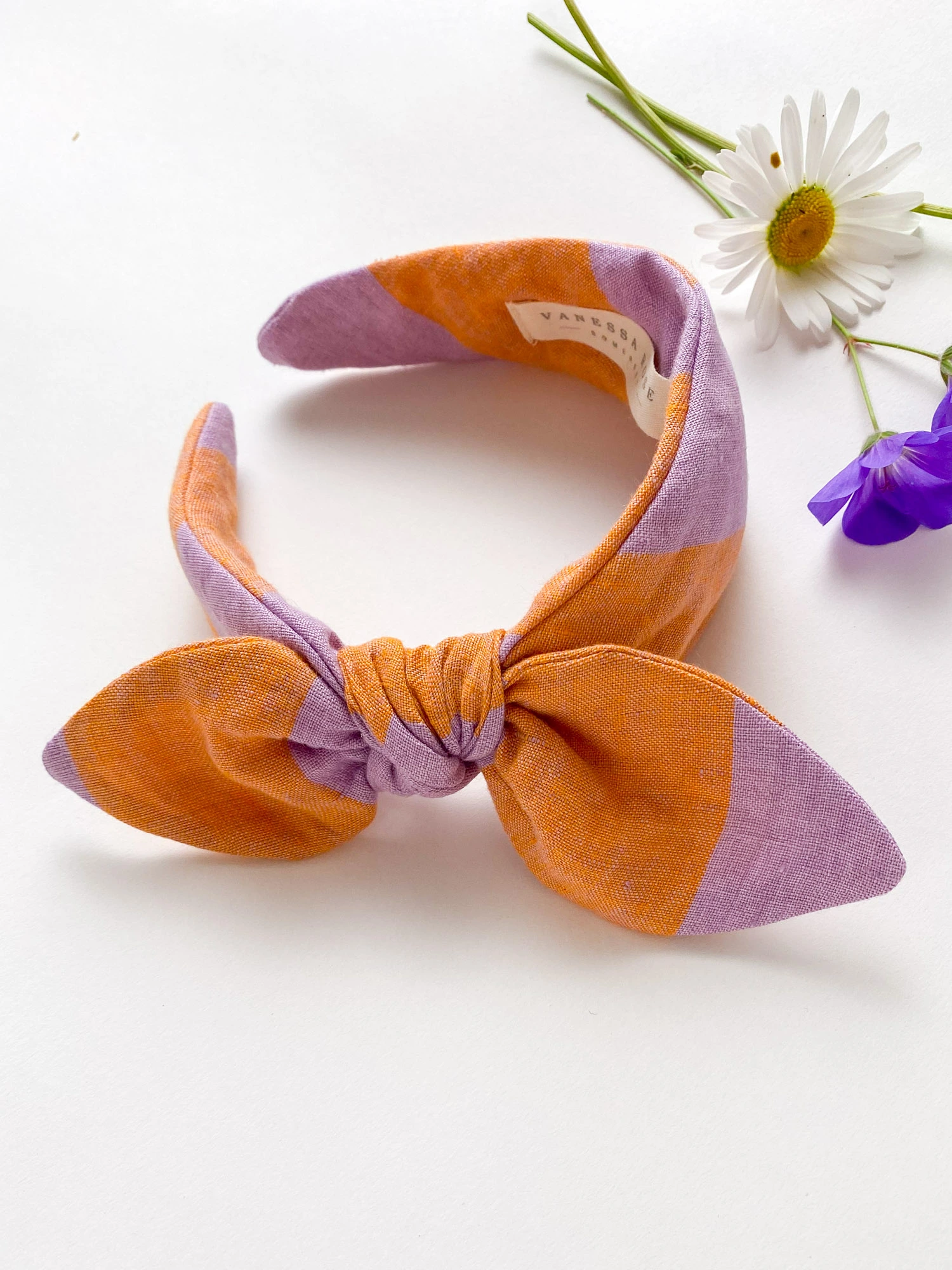 Side Bow headband for women handmade in lilac and orange stripe linen