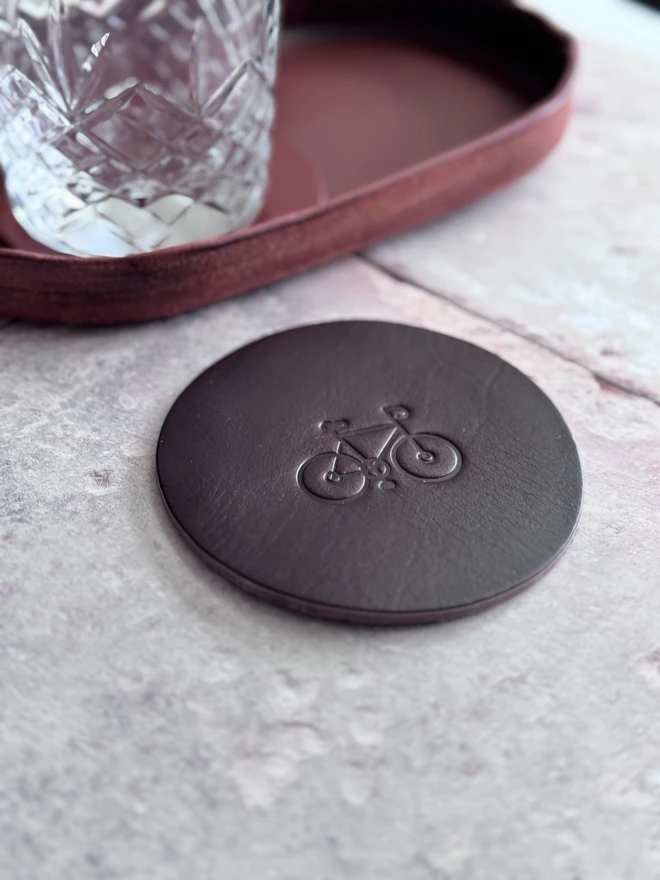 Leather coaster with bike deboss