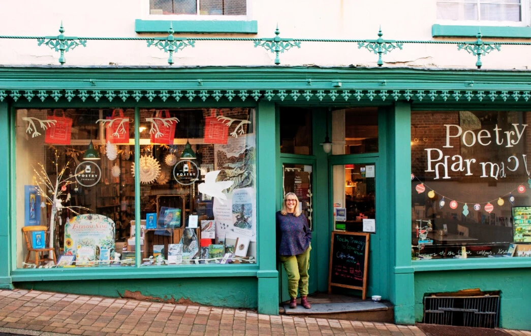 Founder Deborah Alma in the doorway of the Poetry Pharmacy