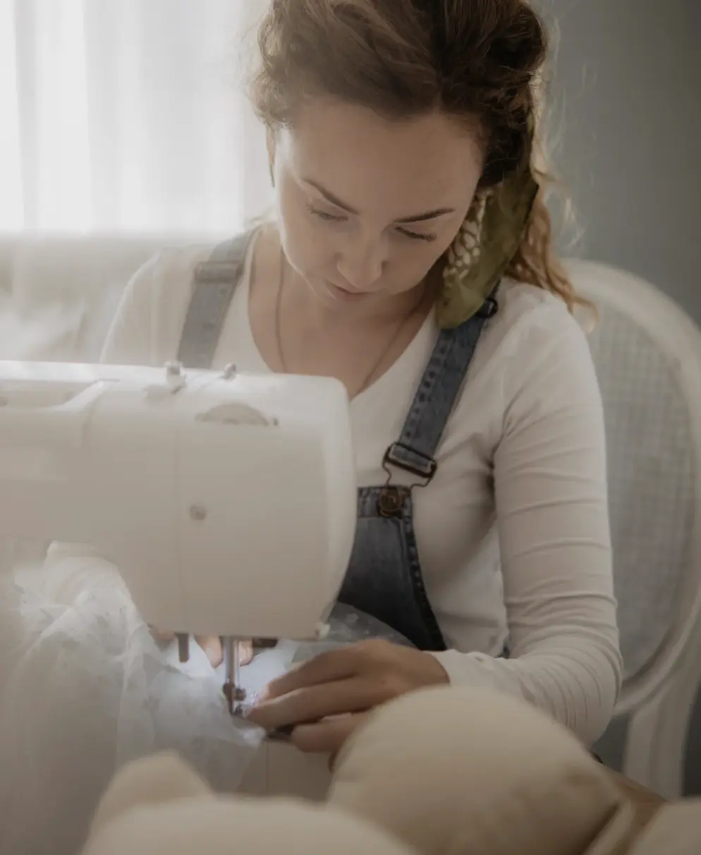 Ola using a sewing machine