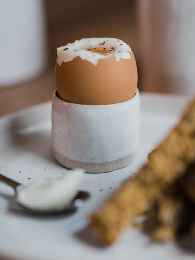 handmade clay egg cup with boiled egg