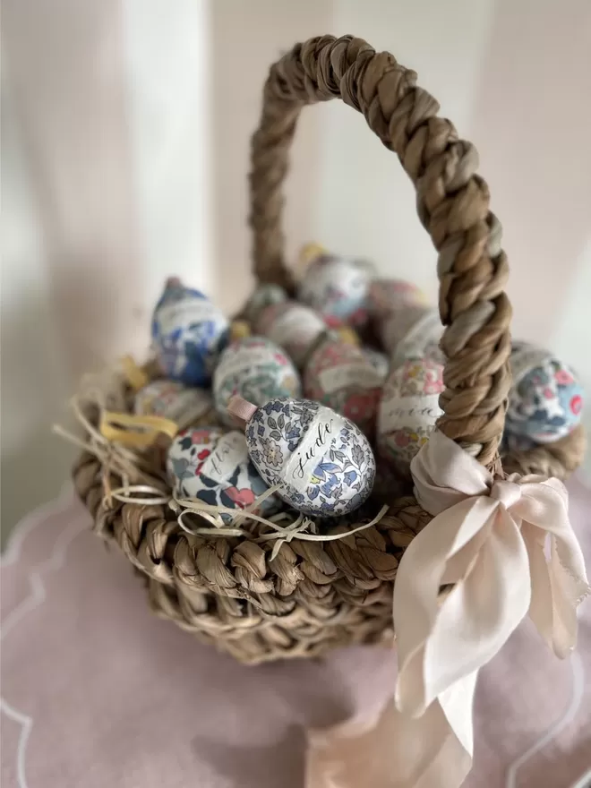 Personalised Liberty fabric decorative eggs in Easter basket with pink ribbon