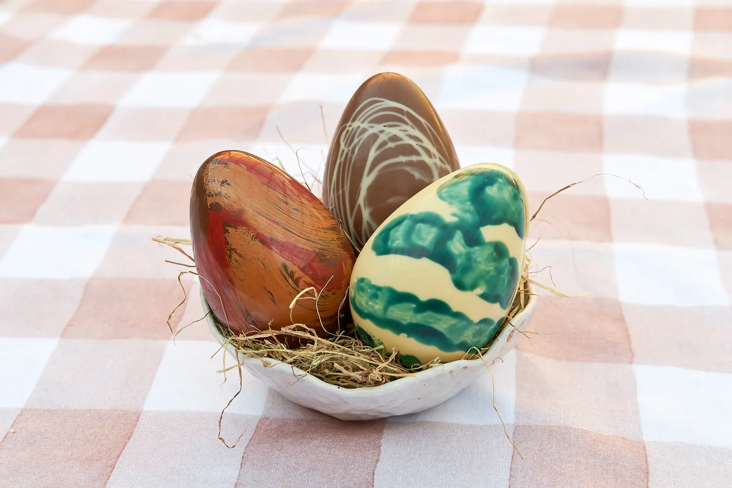 Chocolate eggs. Three different patterned chocolate eggs in a bowl