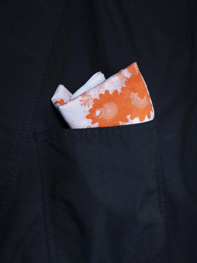 Mr.PS orange flower handkerchief in a dark jacket pocket