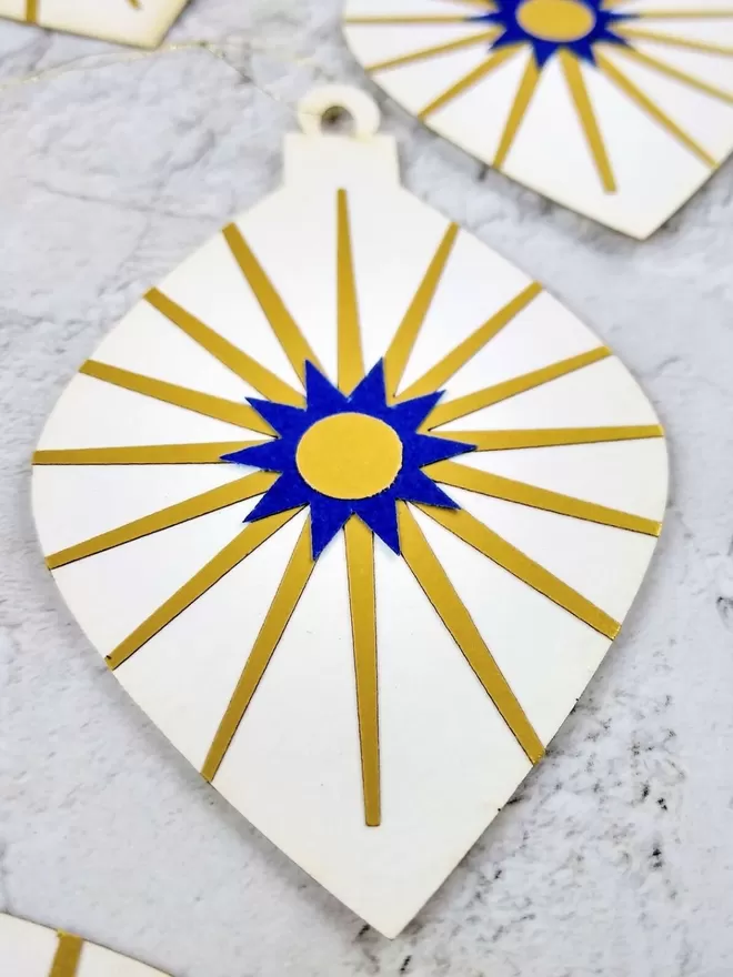Closeup of Gold and blue starburst detail. Gold rays shoot out from royal blue 10 pointed star with gold centre.