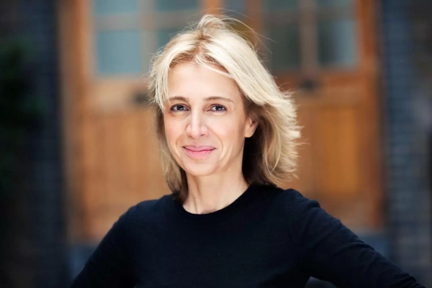 Sahar Hashemi, co-founder of Coffee Republic, smiling at the camera in a black top.