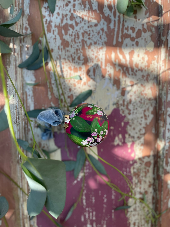 Deep pink hand painted floral bauble adorned with white and pink laurustinus flowers.