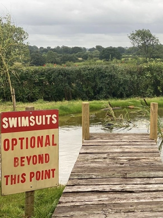 'Swimsuits Optional Beyond This Point' Sign