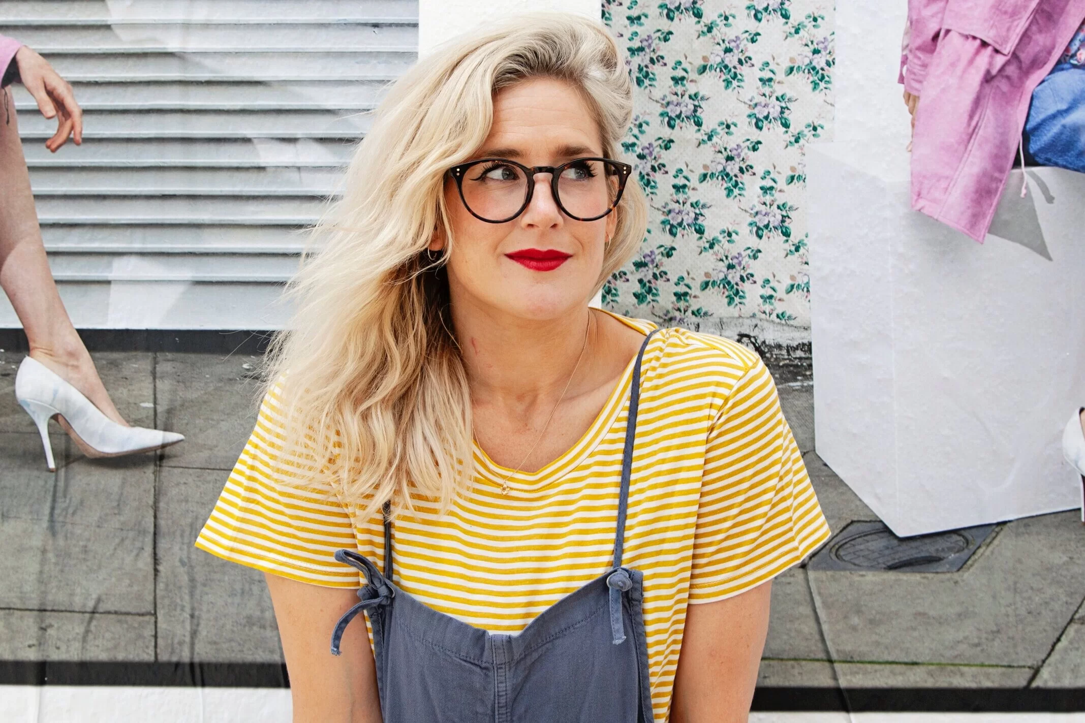 Anna Whitehouse, founder of Mother Pukka, smiling to the side wearing black framed glasses and a white and yellow striped top.