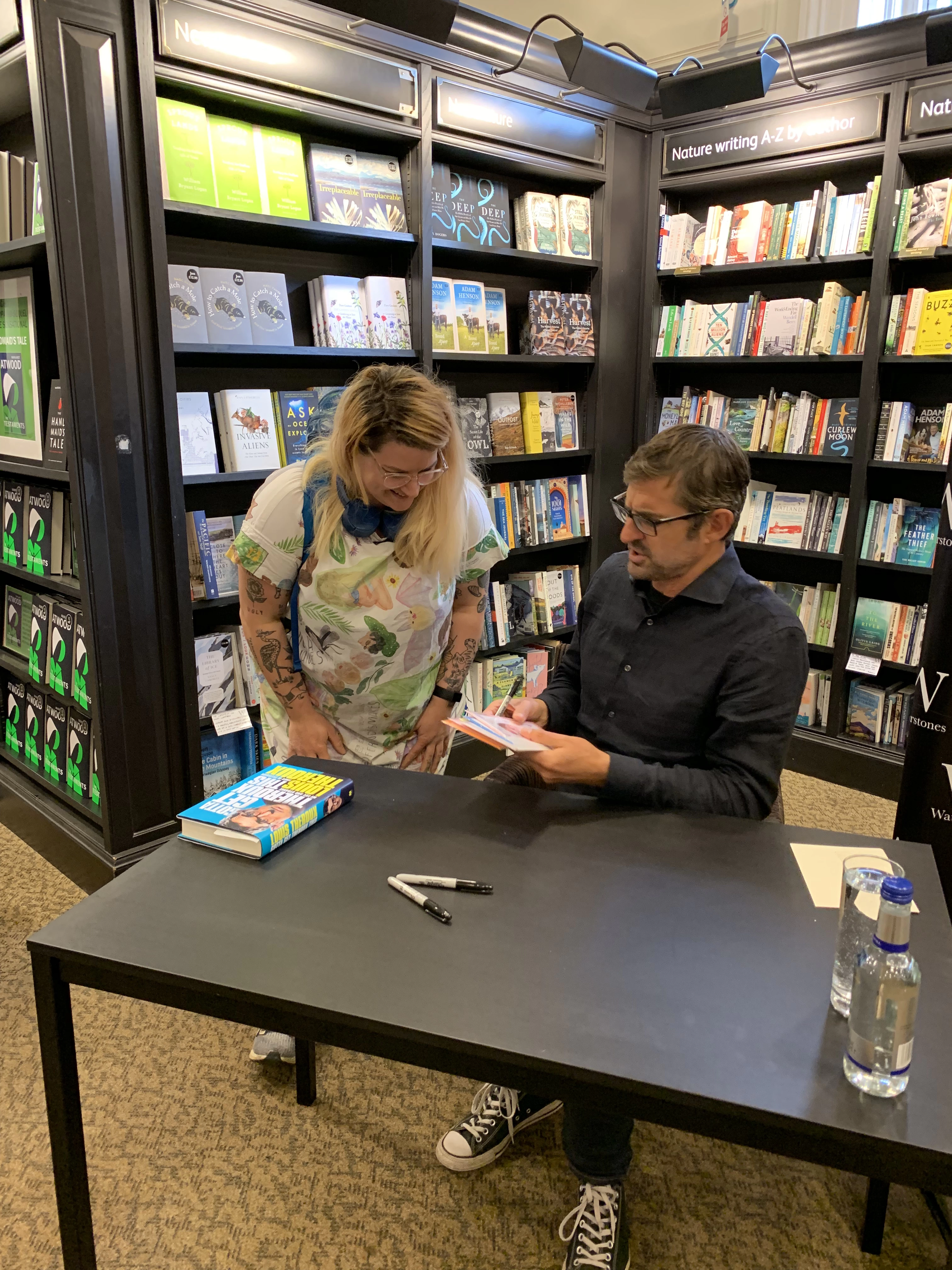 Nicola Fernandes known as Fernandes Makes meeting legend Louis Theroux at a book signing handing over some greeting cards she designed with his face on wearing a dress Nicola handmade with her designs 