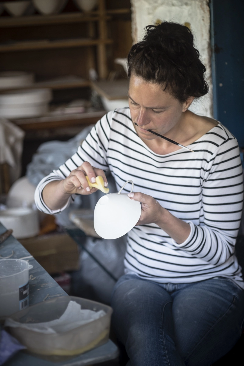 Becky fettling ceramics in the studio