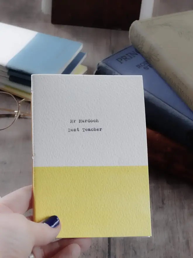 yellow and white personalised notebook with best teacher on the cover