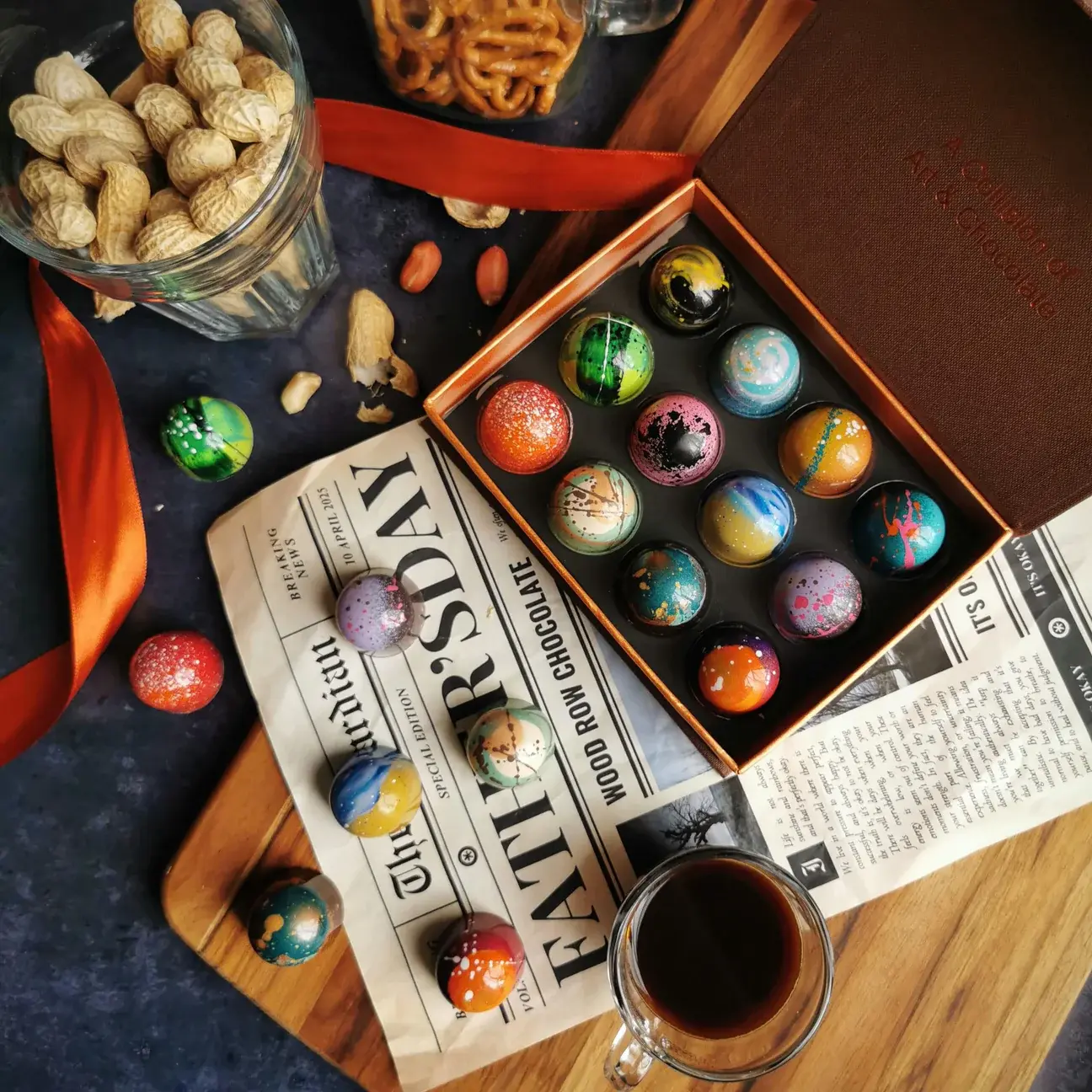display chocolates in and out of a box, with newspaper, peanuts, and coffee