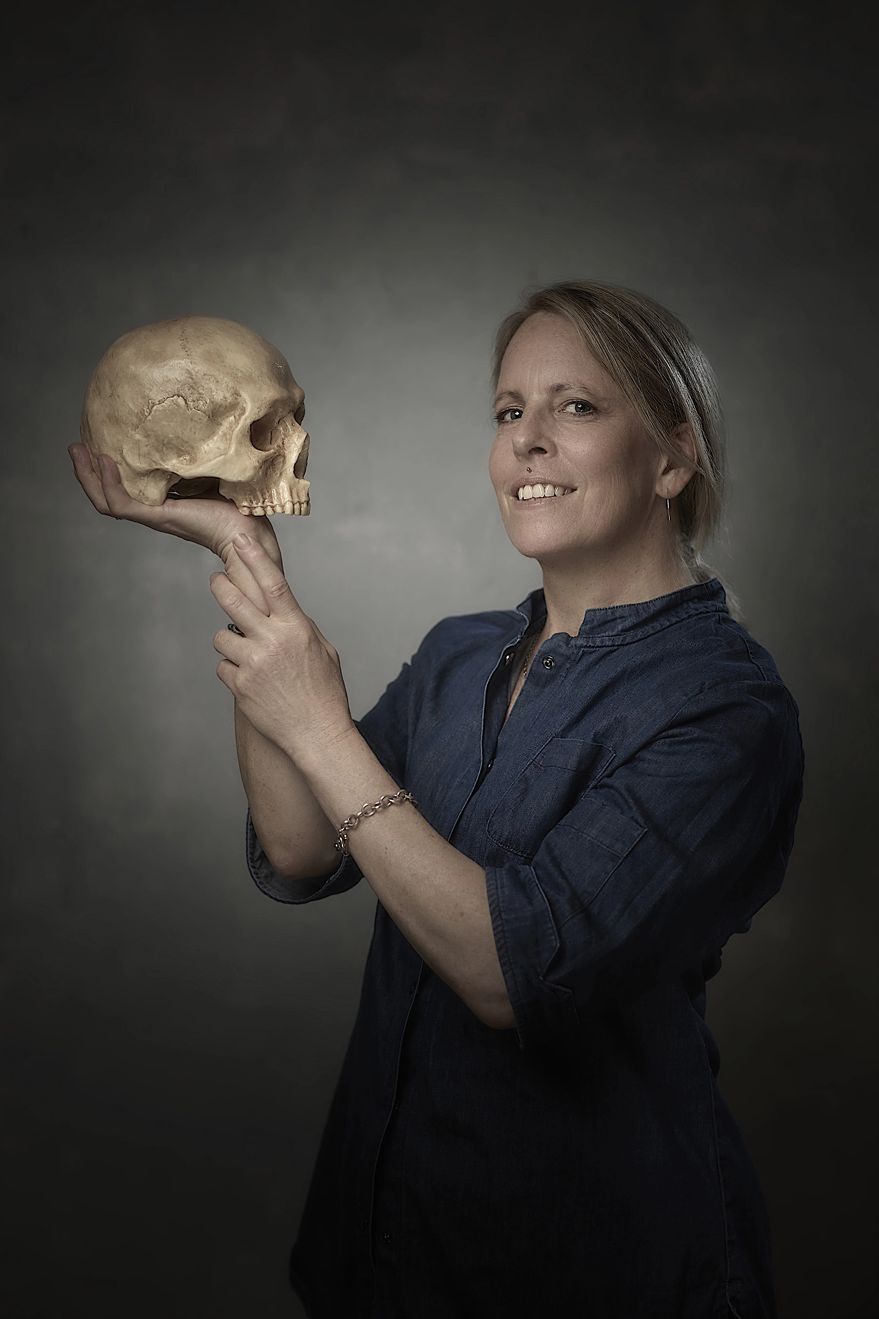 Sarah Hardy smiling and holding a chocolate skull