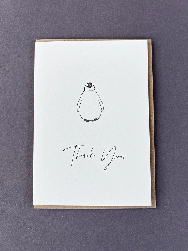 A very cute baby Penguin with "Thank you" beautifully written in a modern calligraphy underneath.
