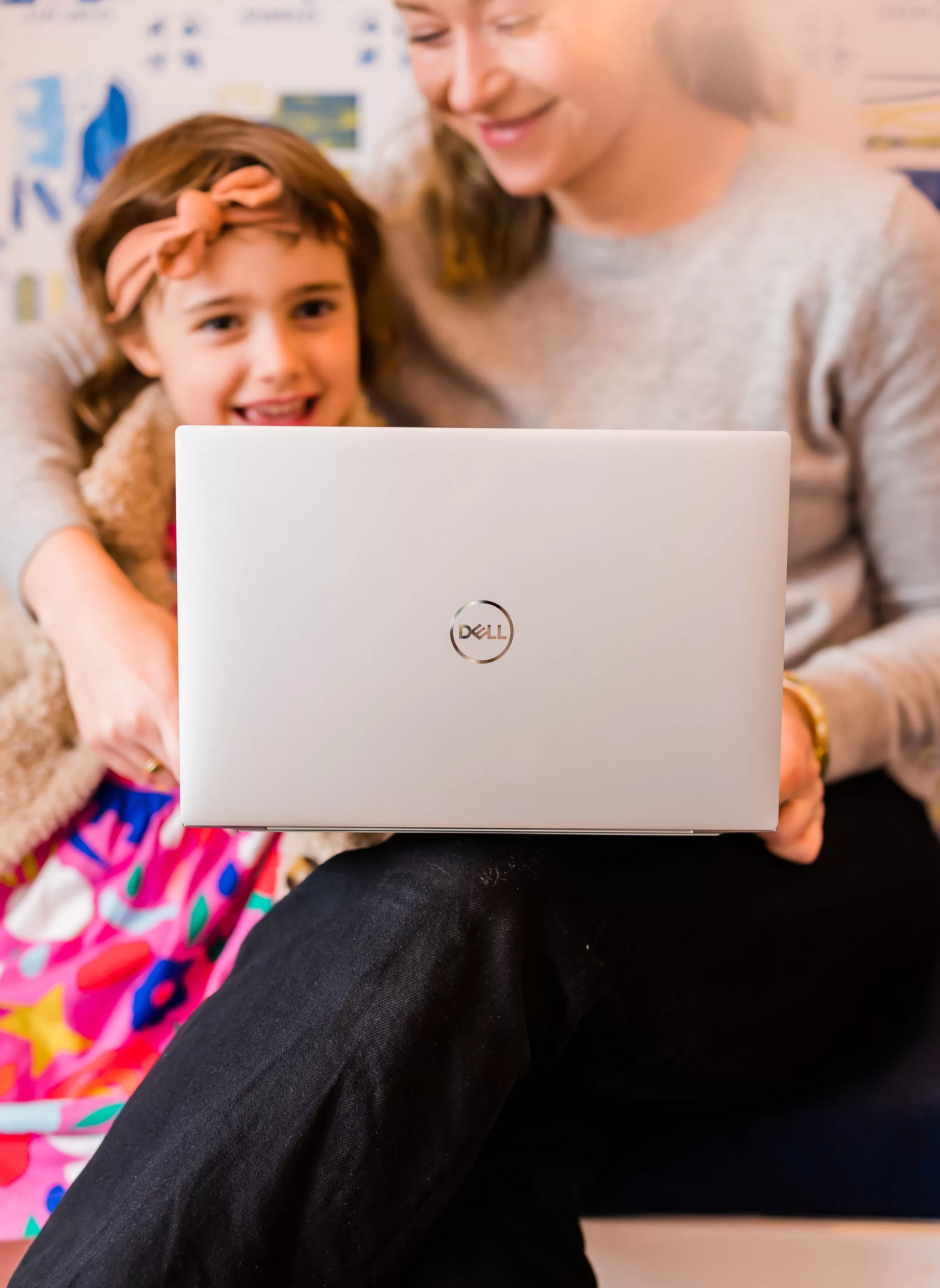 Olive and Hols looking at a Dell laptop sat in the Holly & Co workshop