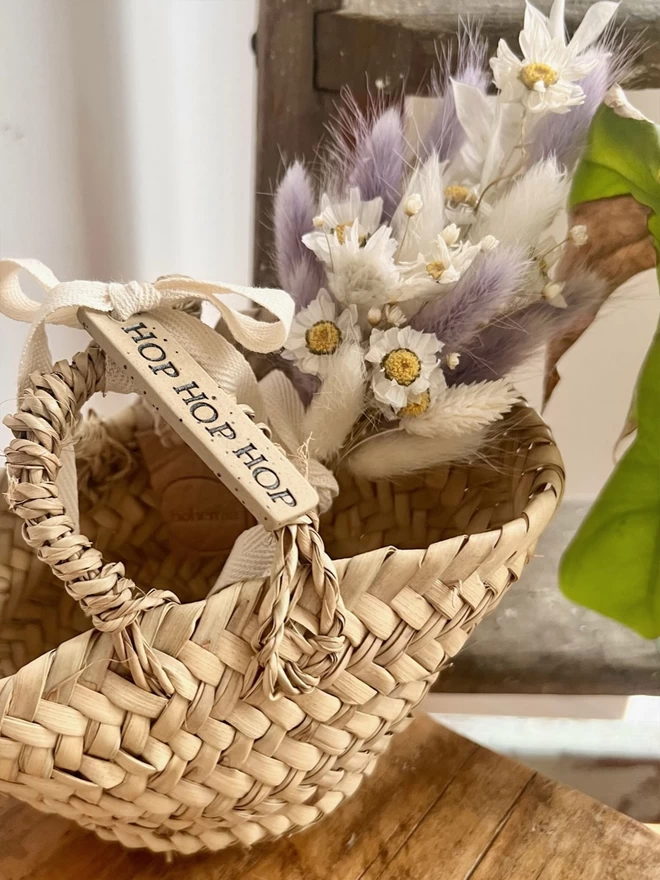 hop hop hop ceramic tag tied around the handle of a basket