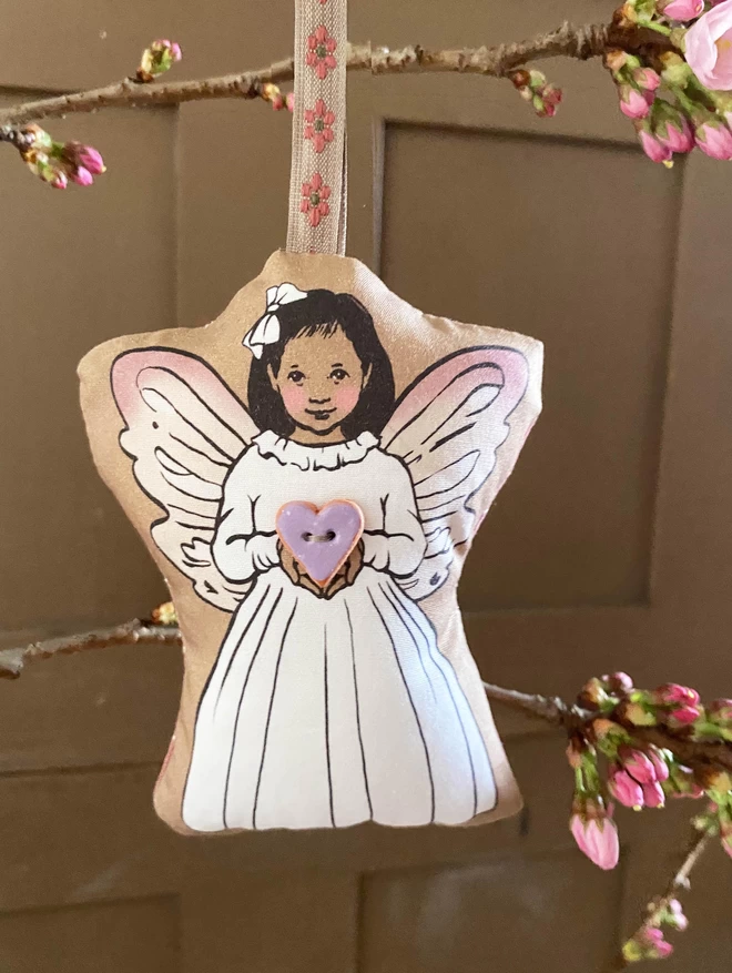 fairy plush with lilac wings holding clay heart button