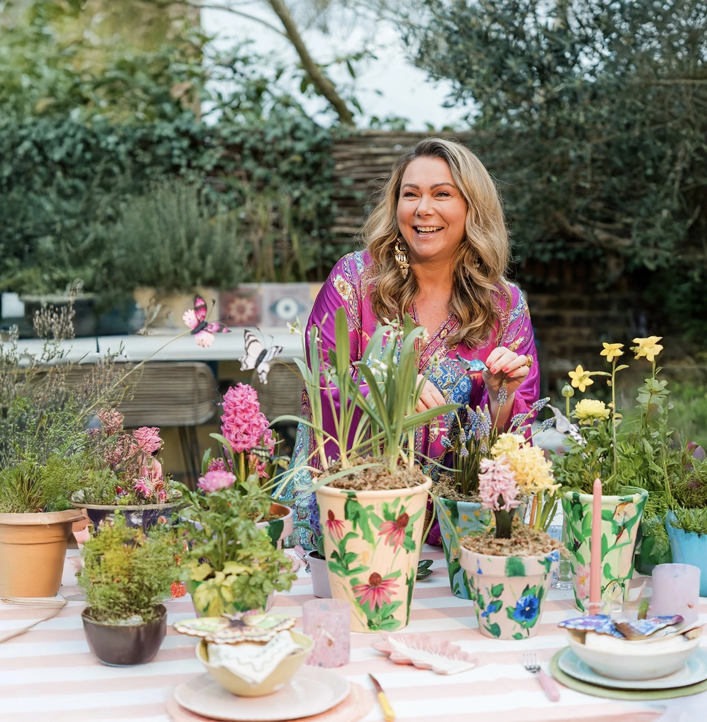 Holly Tucker setting a spring table with hand painted plant pots