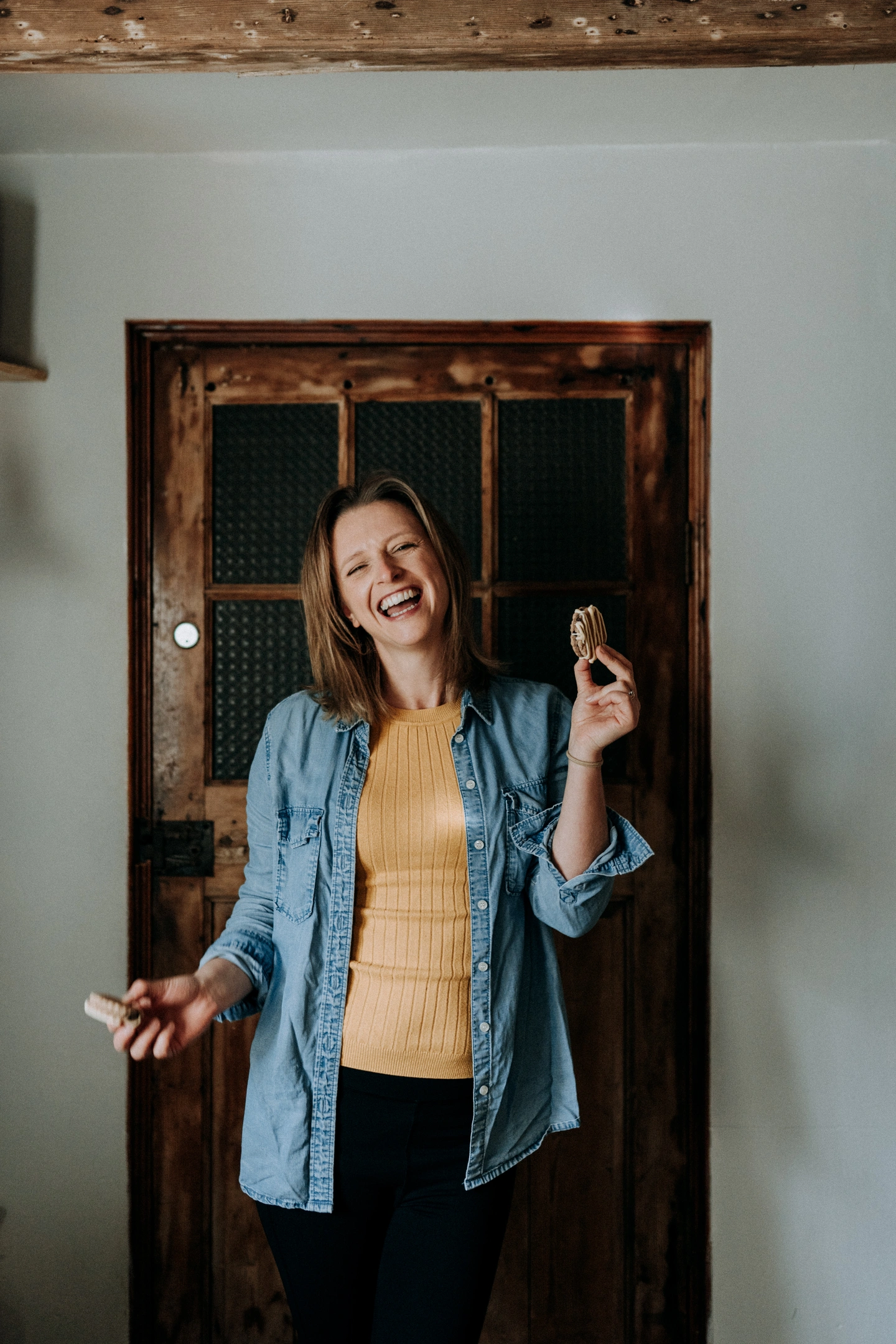 MamGu Welshcakes owner Becky laughing and holding welsh cakes
