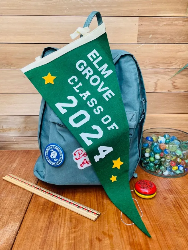Class of 2024 graduation pennant laying on a school bag