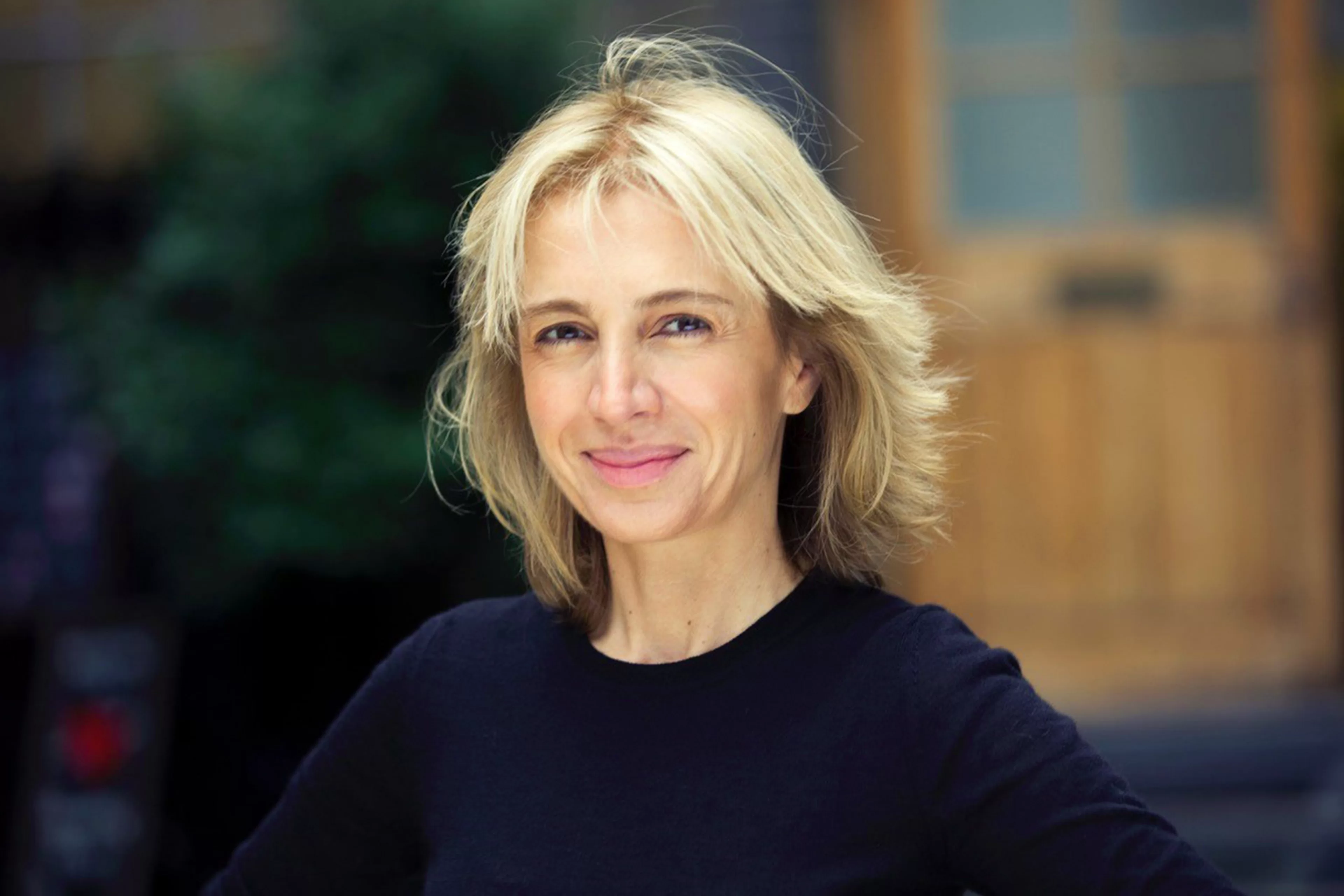 Sahar Hashemi OBE, founder of Coffee Republic smiling at the camera wearing a back top