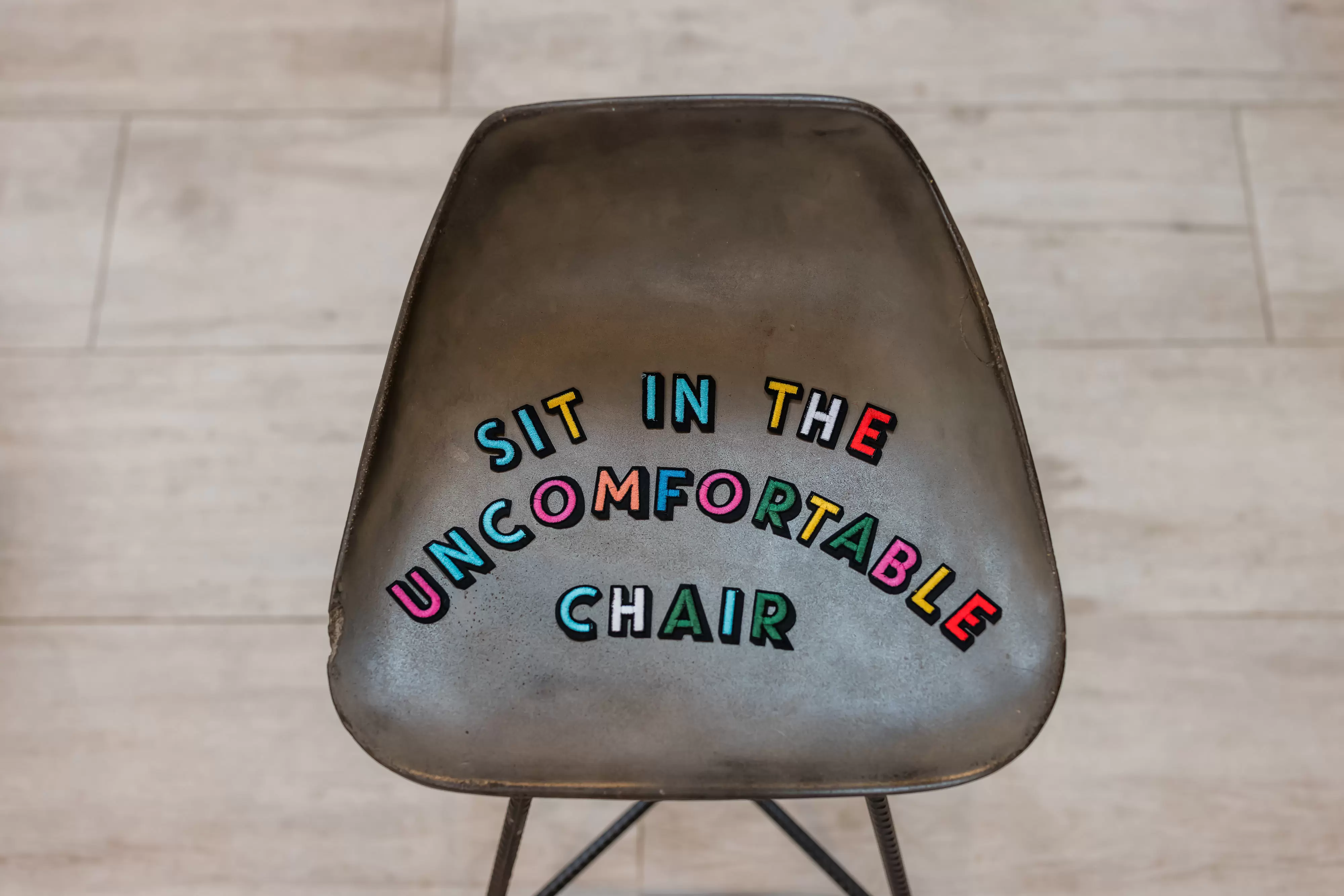 Sit in the uncomfortable chair