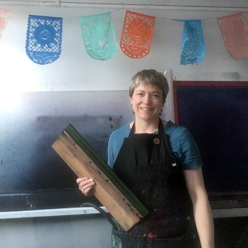 Megan of Mr.PS in the print studio holding a squeegee