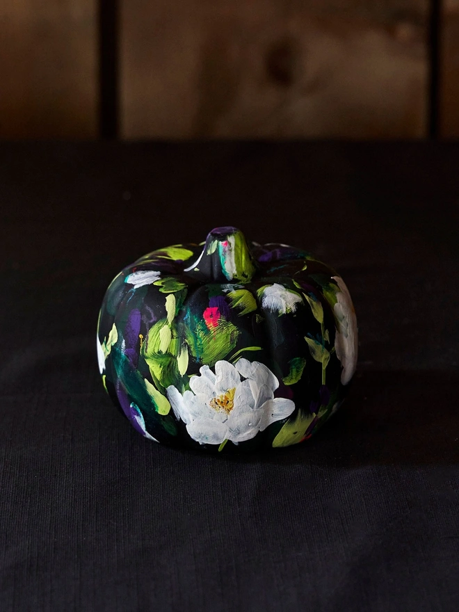 hand painted floral pumpkin black background adorned with white peonies 