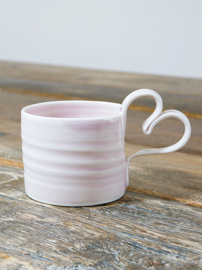 pale pink glaze sat upon a rustic table top