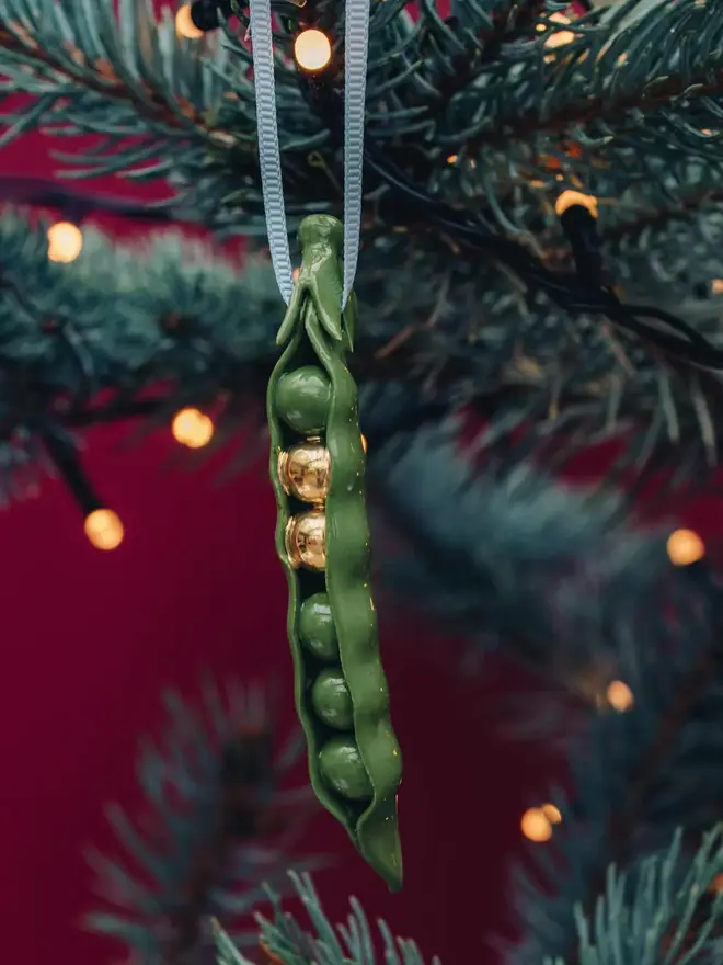 handmade ceramic peas in a pod christmas decoration with two gold peas