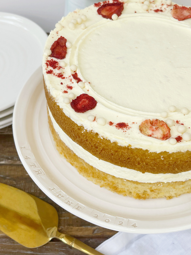 personalised cake stand with extravagant victoria sandwich cake on a table scene