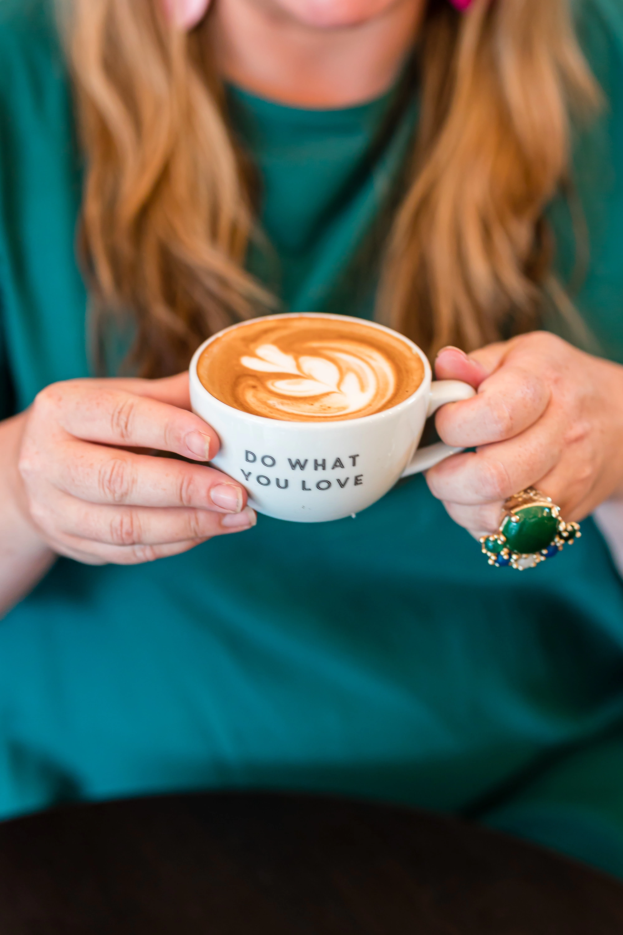 Holly Tucker holding a Do What You Love Mug