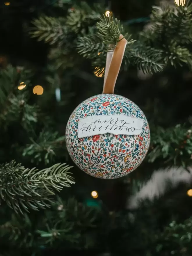 personalised bauble merry christmas on a tree 