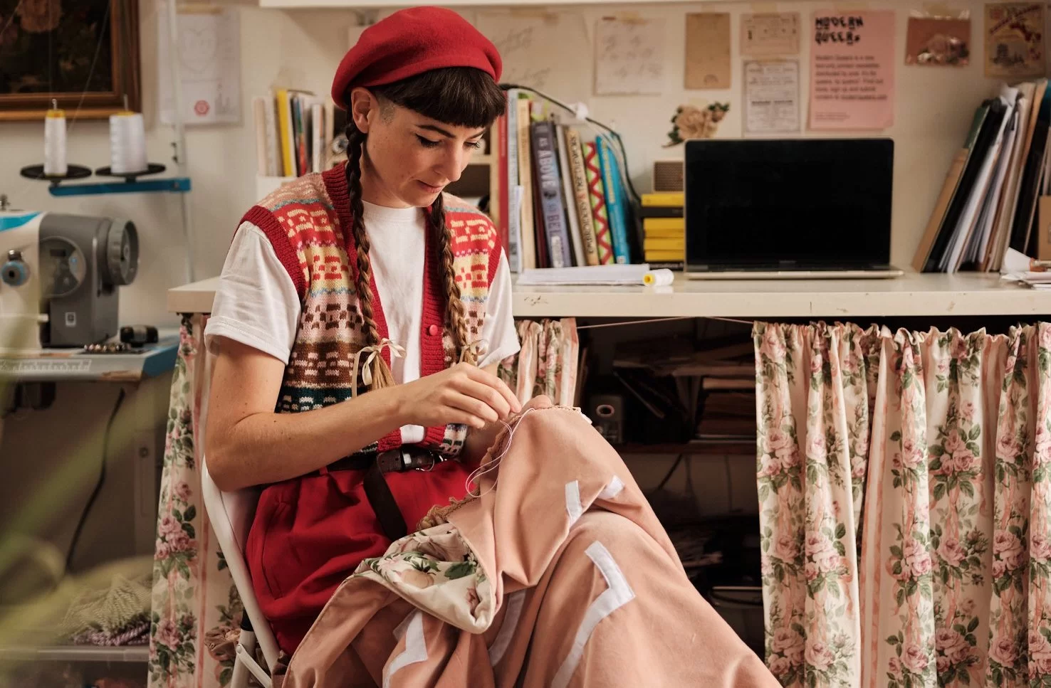 Alice Gabb, artist and illustrator, sewing a banner